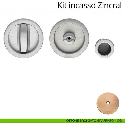 Kit maniglia incasso tonda con nottolino, taglio vite e maniglia di trascinamento Zincral Linea Calì ottone bronzato graffiato